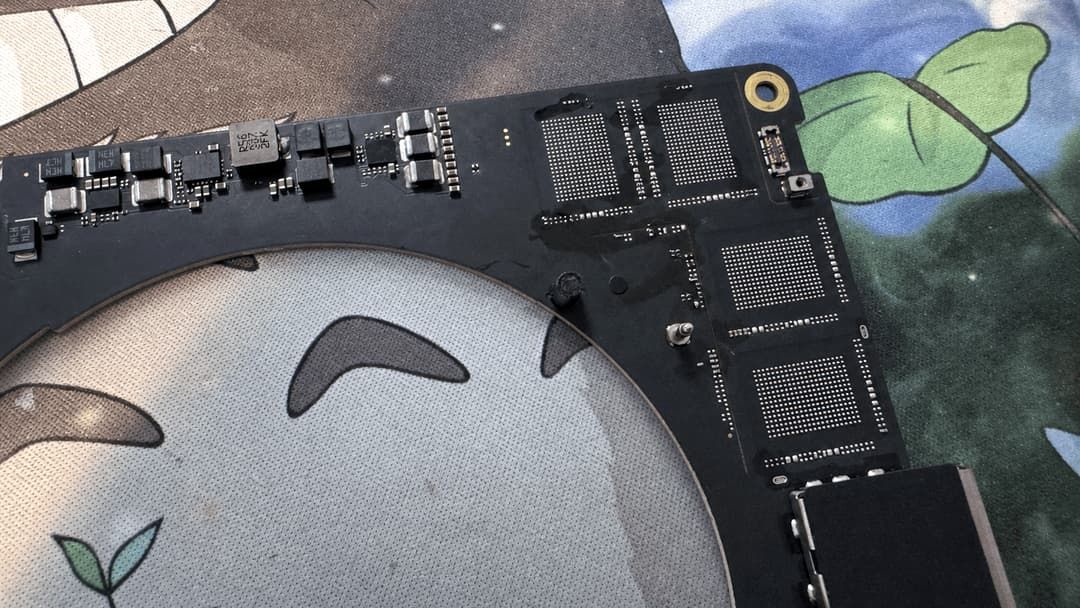 A MacBook Pro's mainboard showing replacement storage chips.