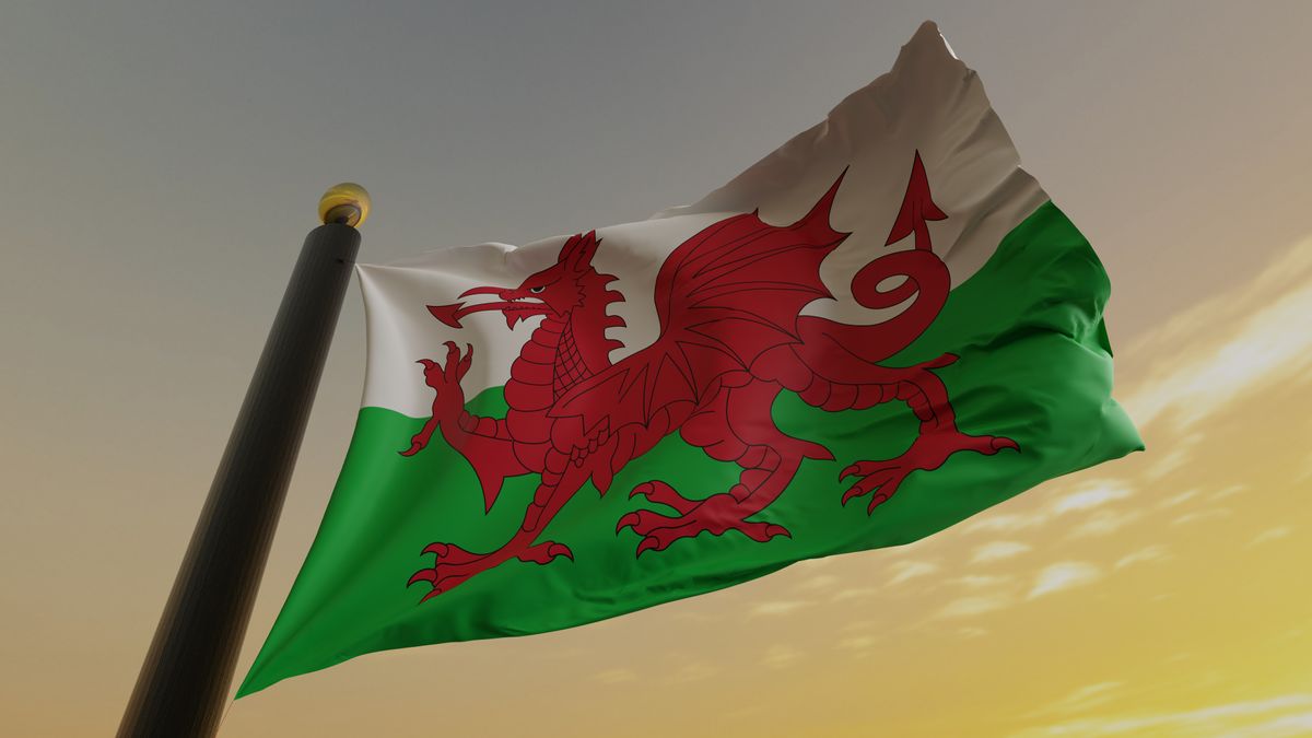 Flag of Wales against a sunset backdrop