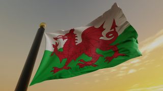 Flag of Wales against a sunset backdrop