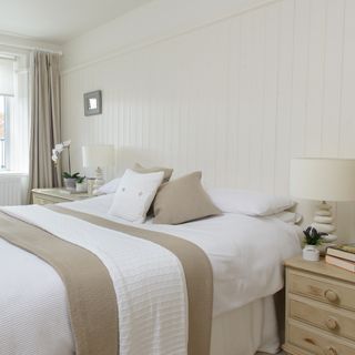 Neutral bedroom with white wall panelling