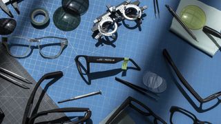 Glasses parts are strewn across a workbench, hinting at the return of Google Glass