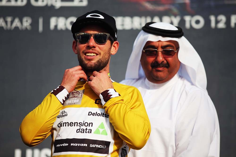 Mark Cavendish (Dimension Data) pulls on the first leader's gold jersey