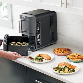 an air fryer and assorted food