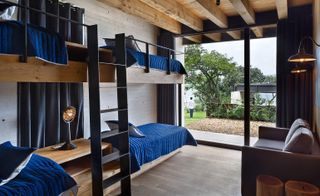 Some of the bedrooms are arranged as informal sleeping bunks, leading to private gardens outside
