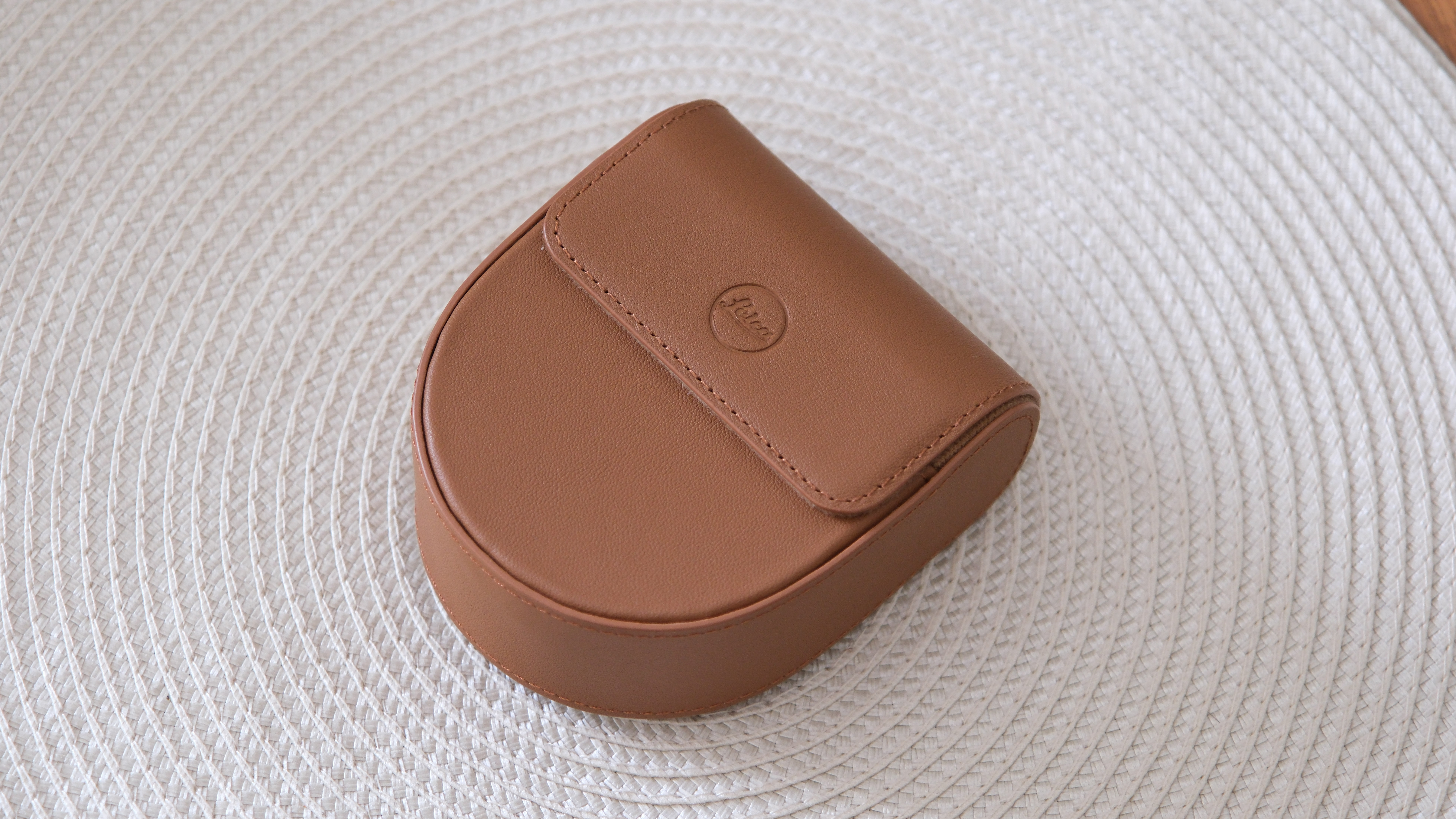 Leica Lux Grip leather case on a beige placemat