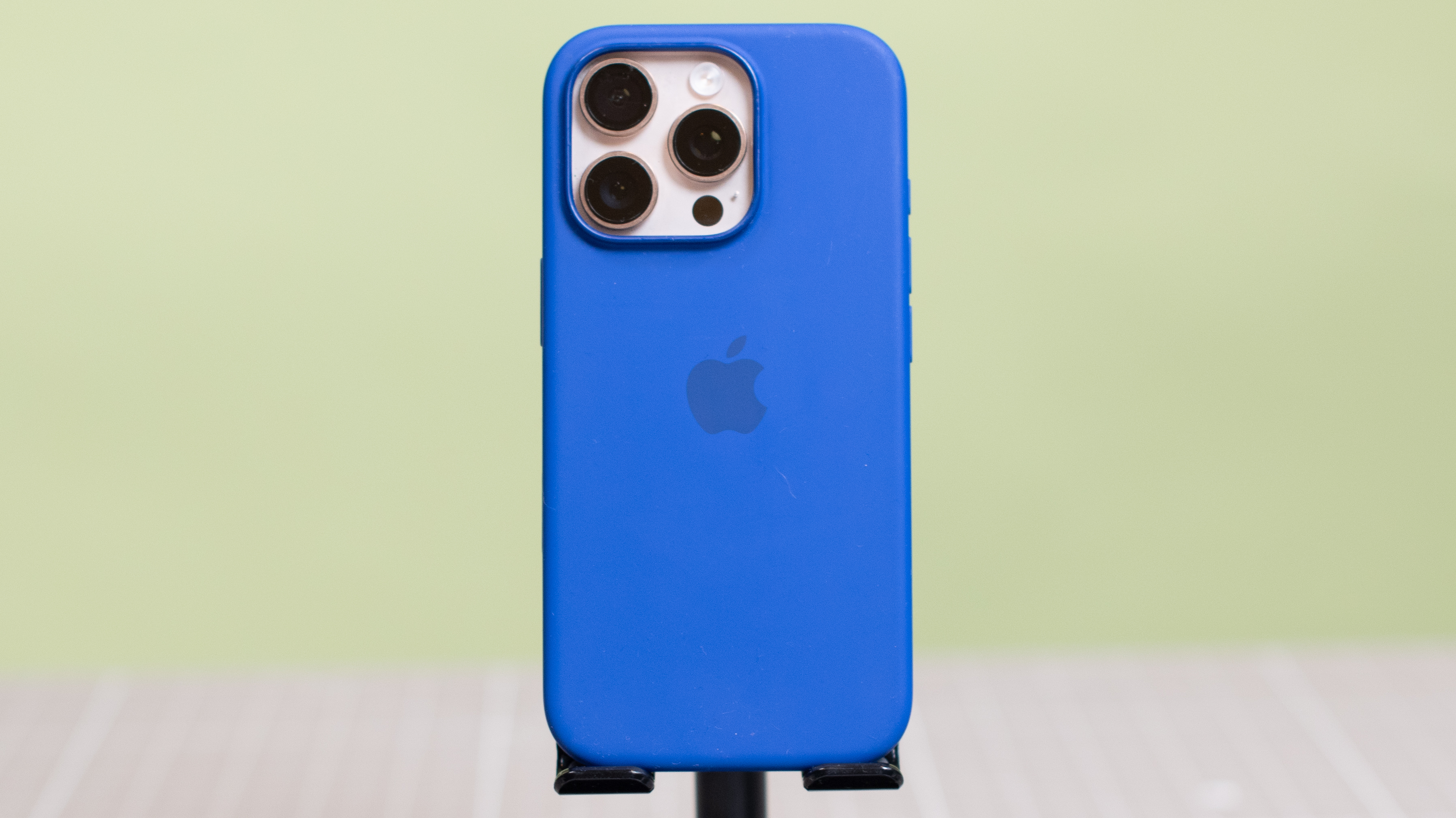 Apple iPhone 16 Pro Silicone Case from back showing Apple logo with desert titanium Apple iPhone 16 Pro inside