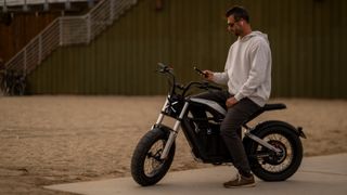 Man riding Segway Xyber over sand.