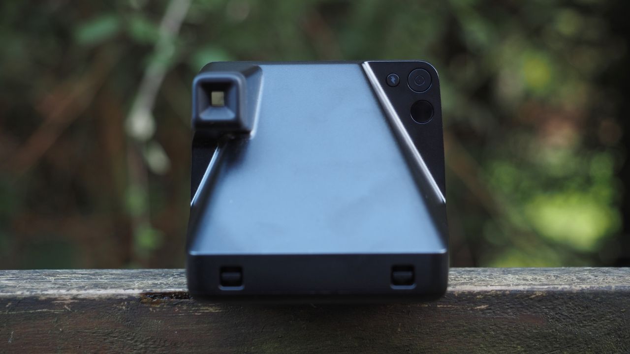Polaroid Now+ Generation 2 on a wooden surface, in a woodland setting