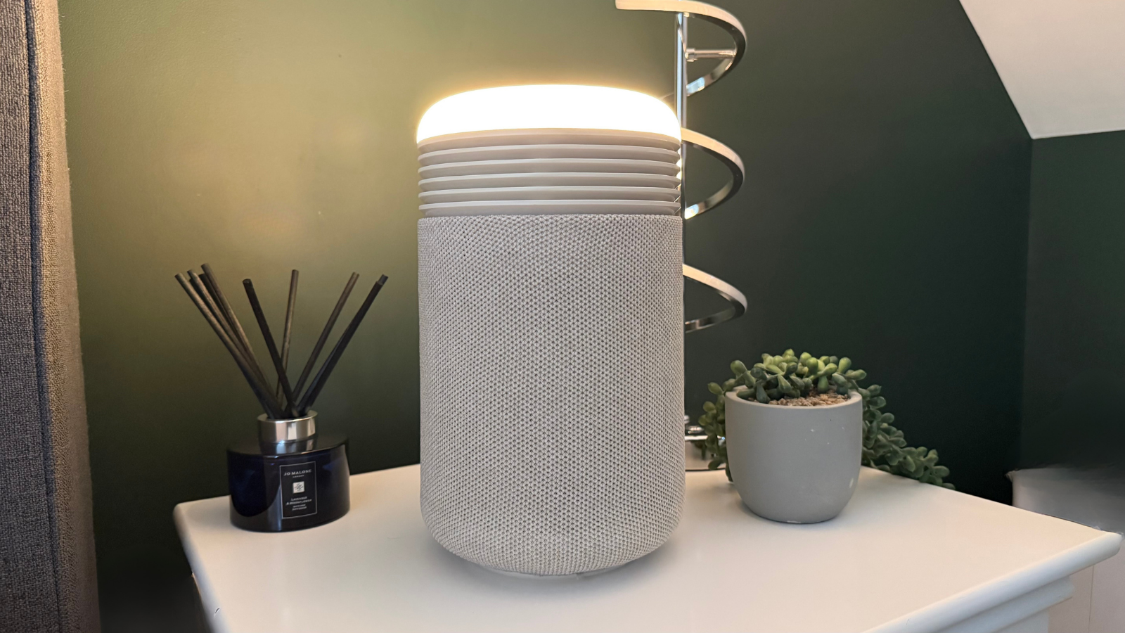 Blueair Mini Restful operating as a bedside night light with a warm glow in a dark bedroom