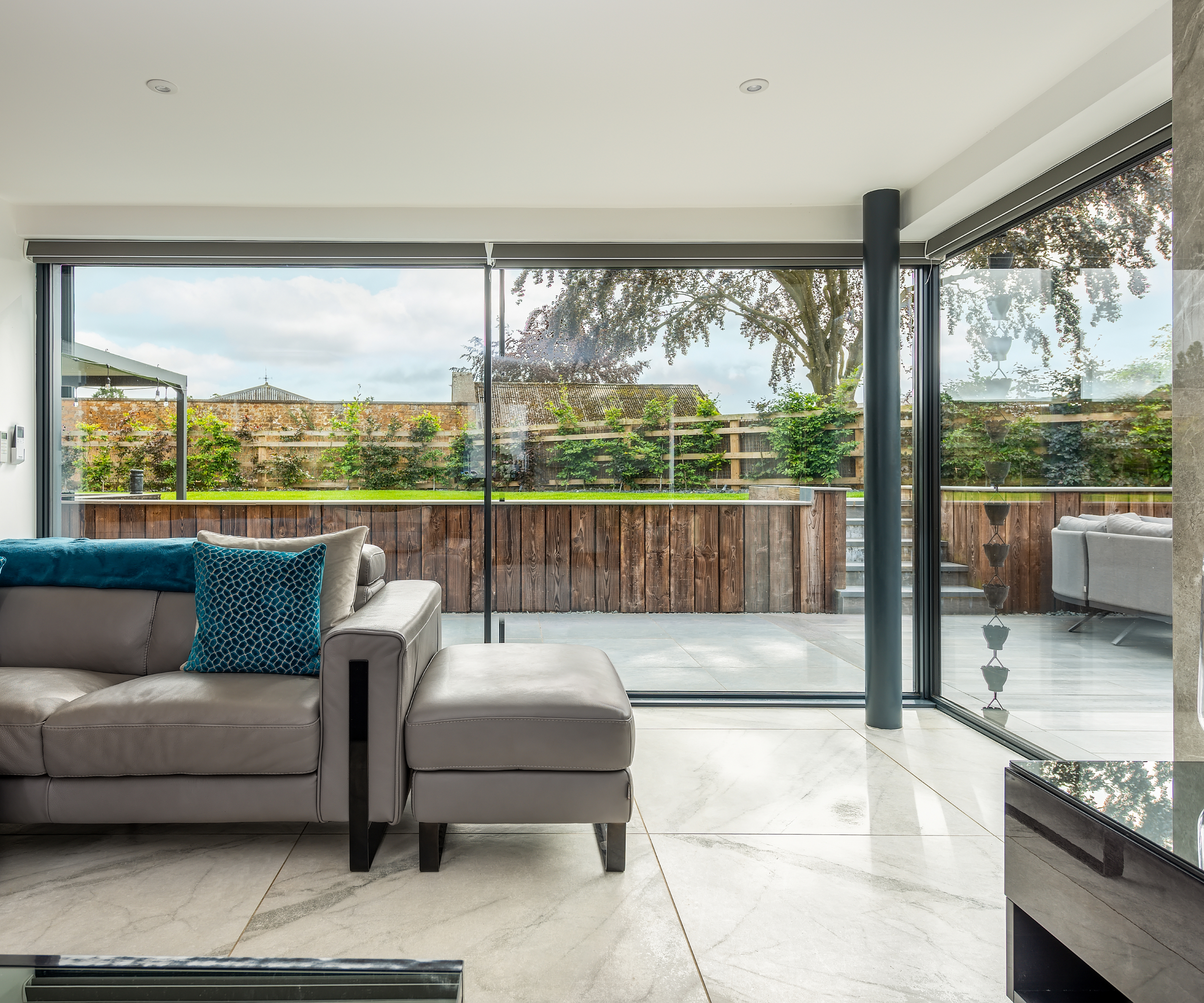 sliding patio doors running along the two sides of a living room, meeting at a corner