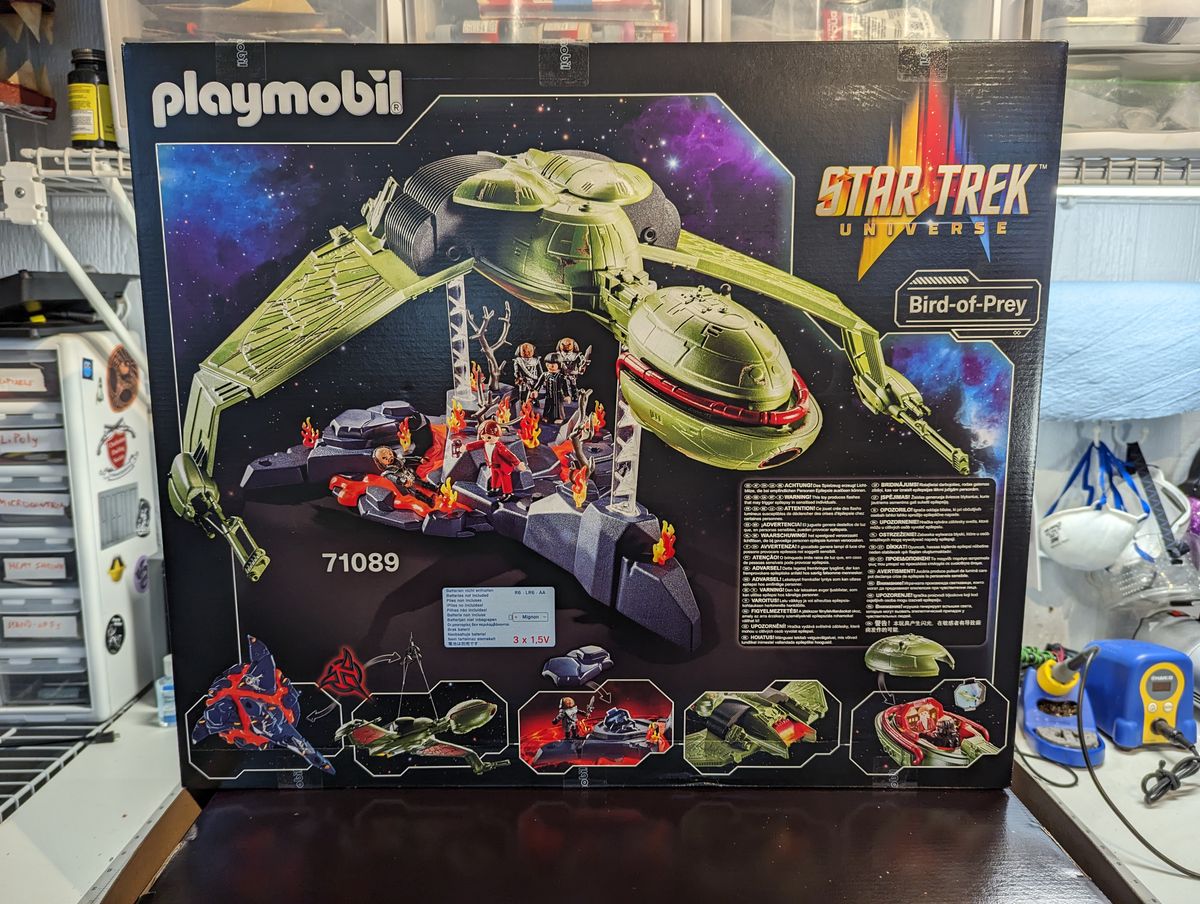 a child assembles a klingon bird of prey on a workbench
