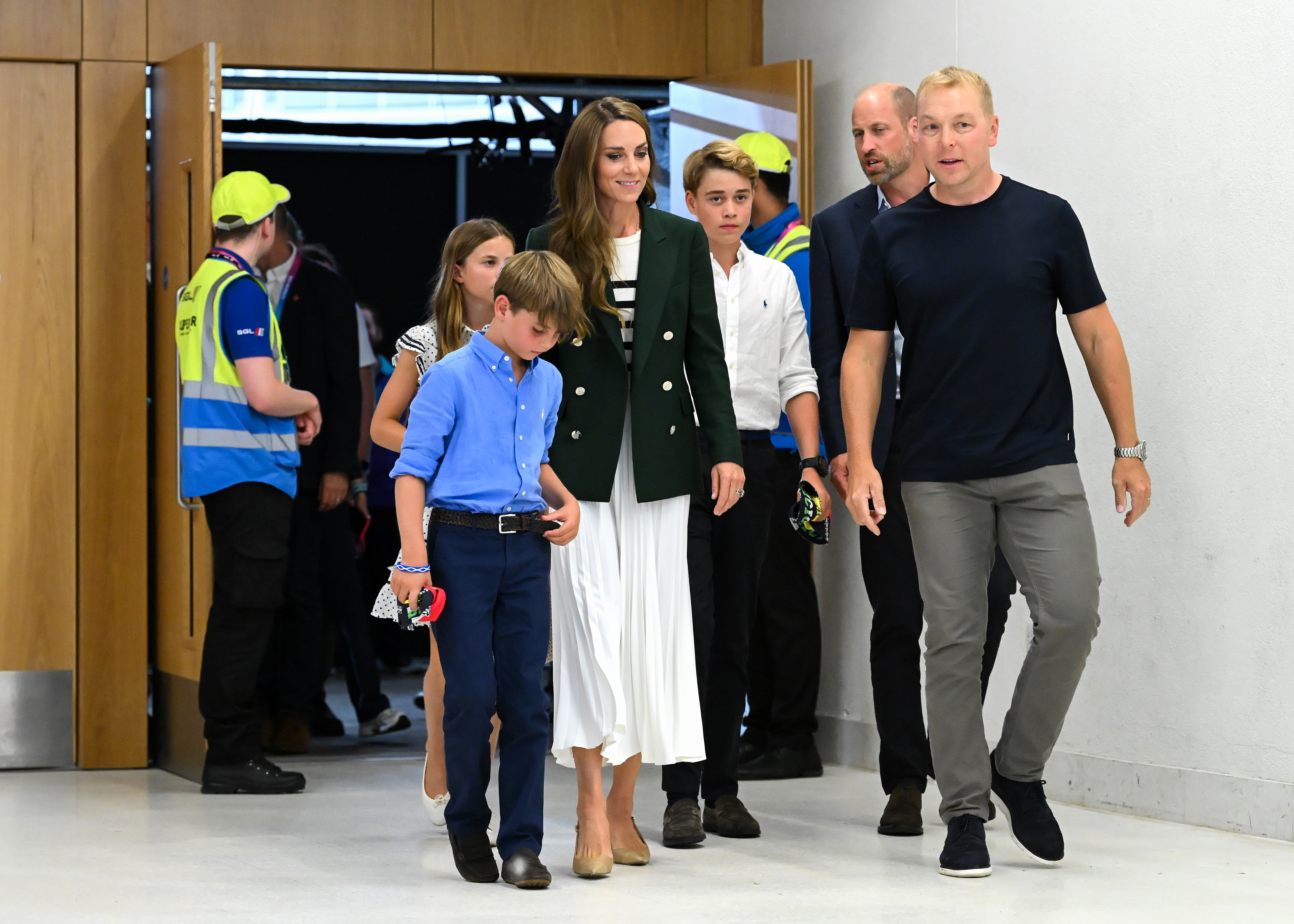 Princess Kate, Prince Louis, Prince George, Princess Charlotte and Prince William walking with Sir Chris Hoy at the Commonwealth Games