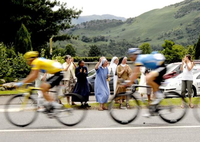 Tour de France 2008 - Stage 10. The maillot jaune worn by Kim Kirchen hurtles by a group of excited nuns who cheer on the peloton