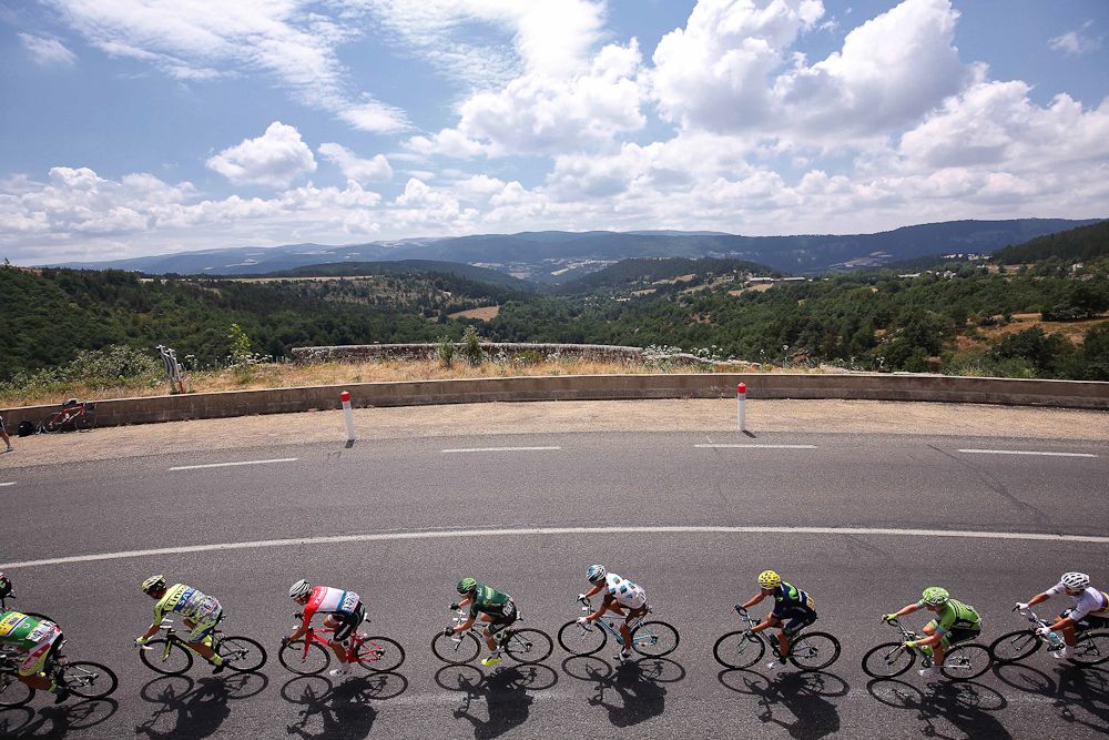 The peloton rolls through the French countryside during stage 15.