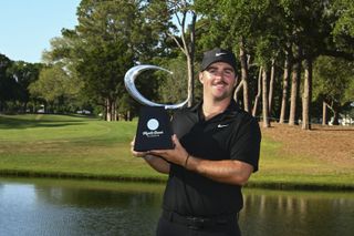 Chris Gotterup holds the Mytrle Beach Classic trophy