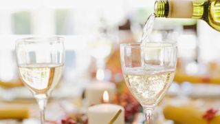 White wine being poured into wine glasses