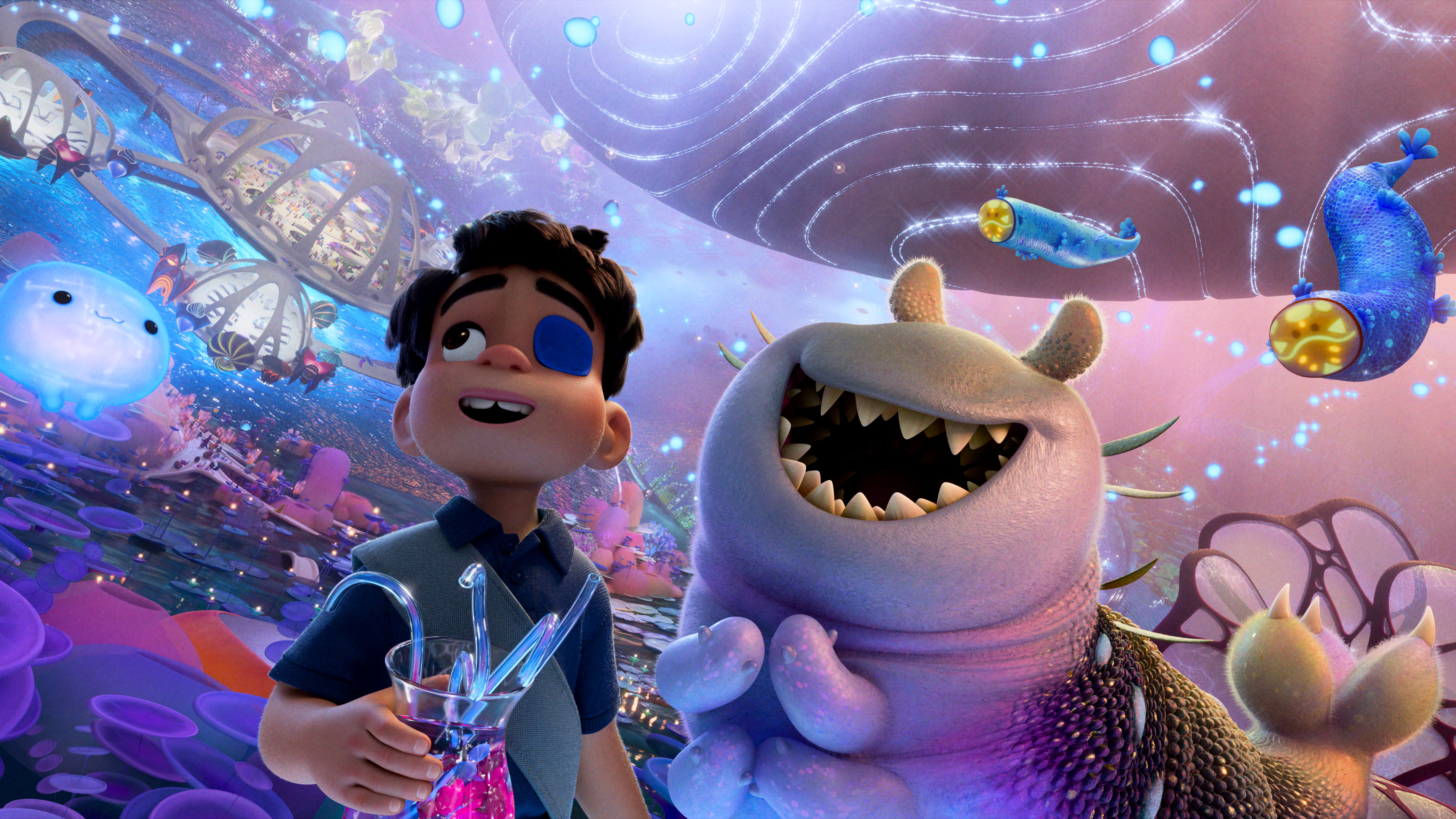 L-R: Elio and Glordon standing in the middle of the Communiverse, accompanied by liquid supercomputer OOOOO in a scene from "Elio"