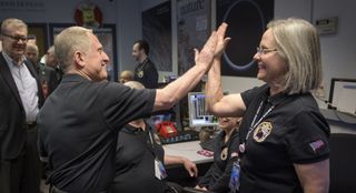 High five between two New Horizons team members