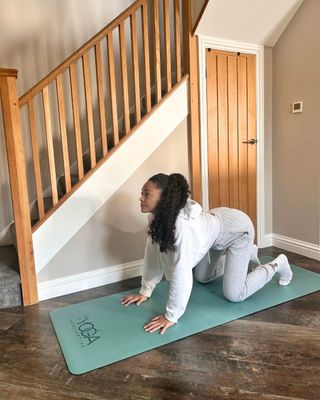 Health writer Rebecca trying the yoga pose cat cow every day from home