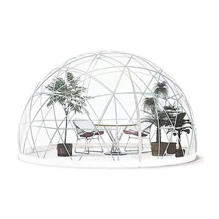 Clear deodome set up with chairs and plants inside.