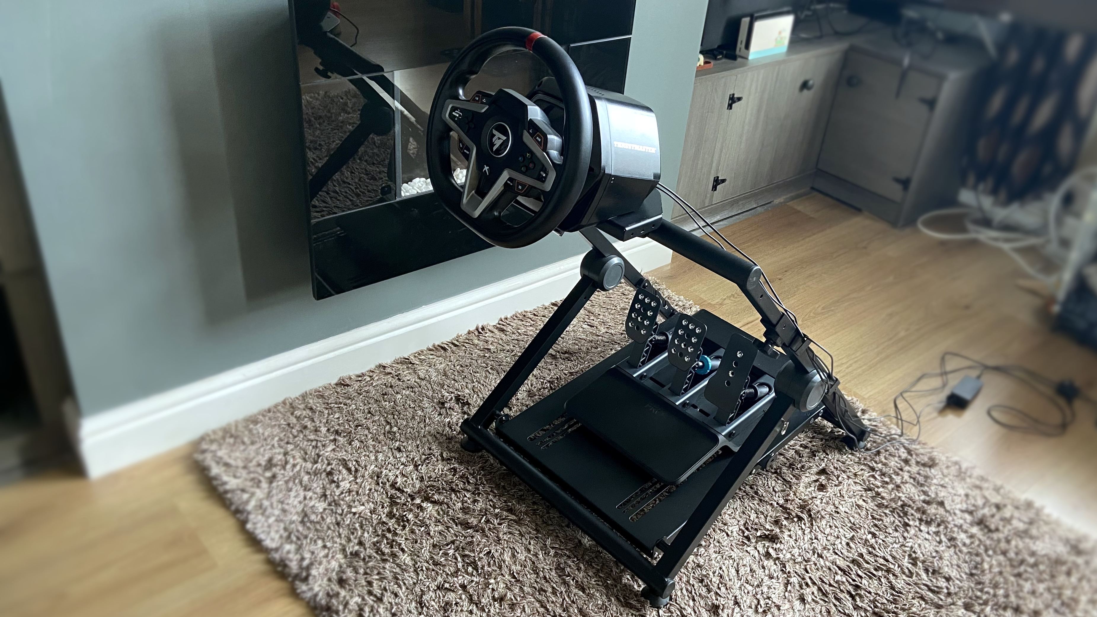 GT foldable racing stand fully assembled with a Thrustmaster T248X wheel and Logitech G PRO pedals.
