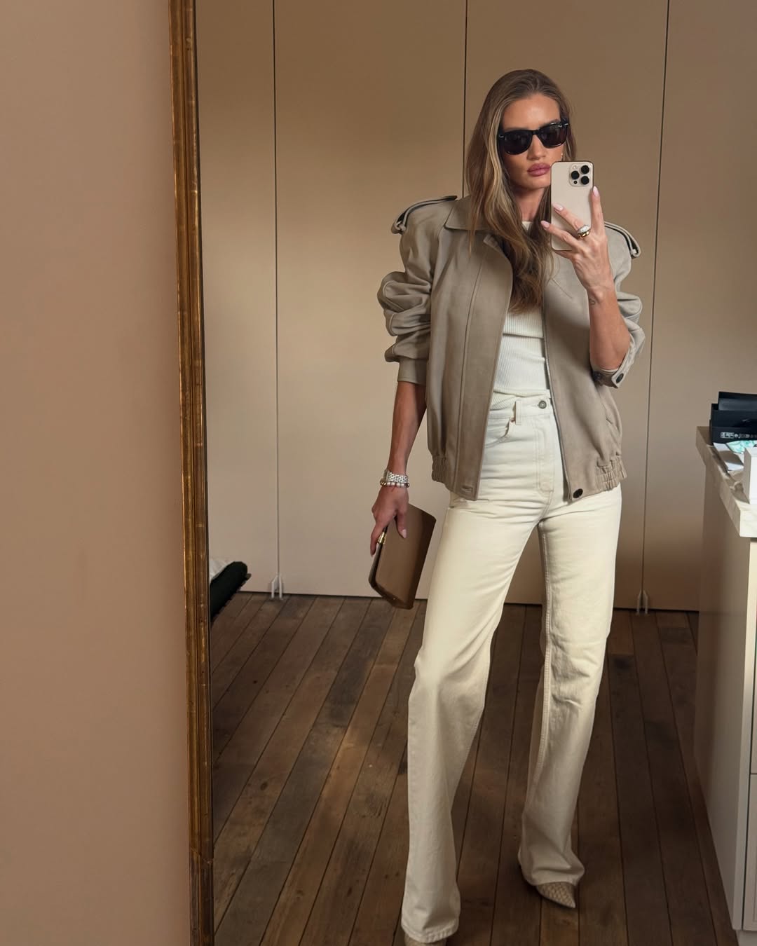 Rosie Huntington-Whiteley wearing high-rise bootcut jeans.