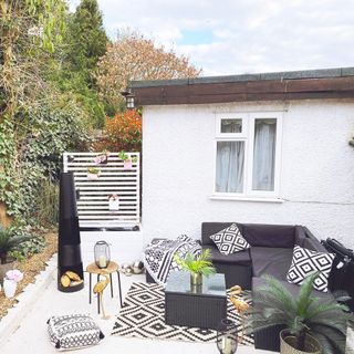 patio area makeover with grey sofa and carpet