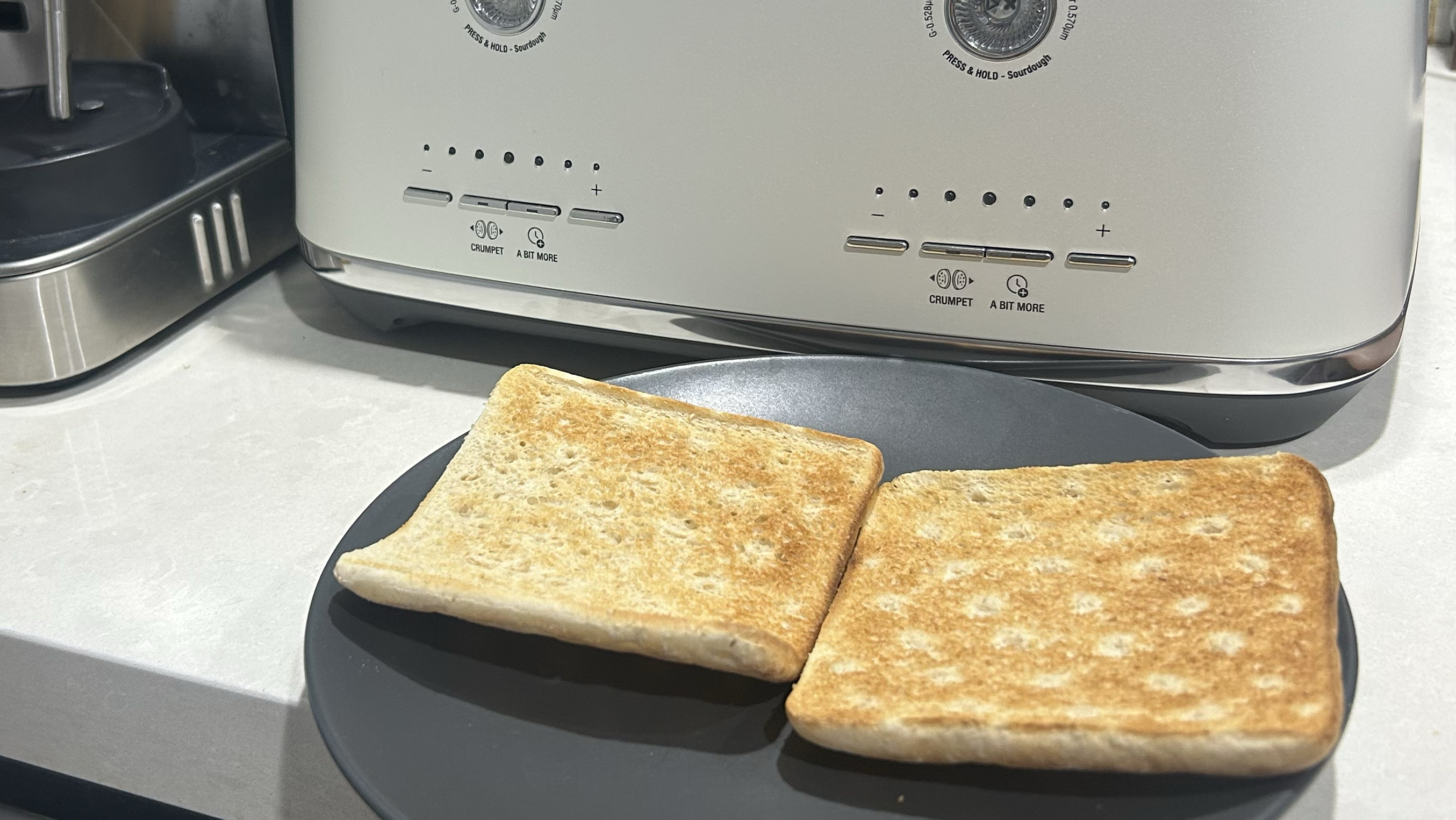 Low carb toasted bread on grey plate with white Breville toaster in background