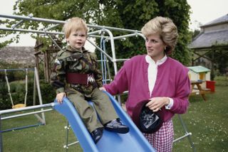 Prince Harry wearing the uniform of the Parachute Regiment of the British Army in the garden of Highgrove House in Gloucestershire, 18th July 1986. He is accompanied by his mother, Diana, Princess of Wales