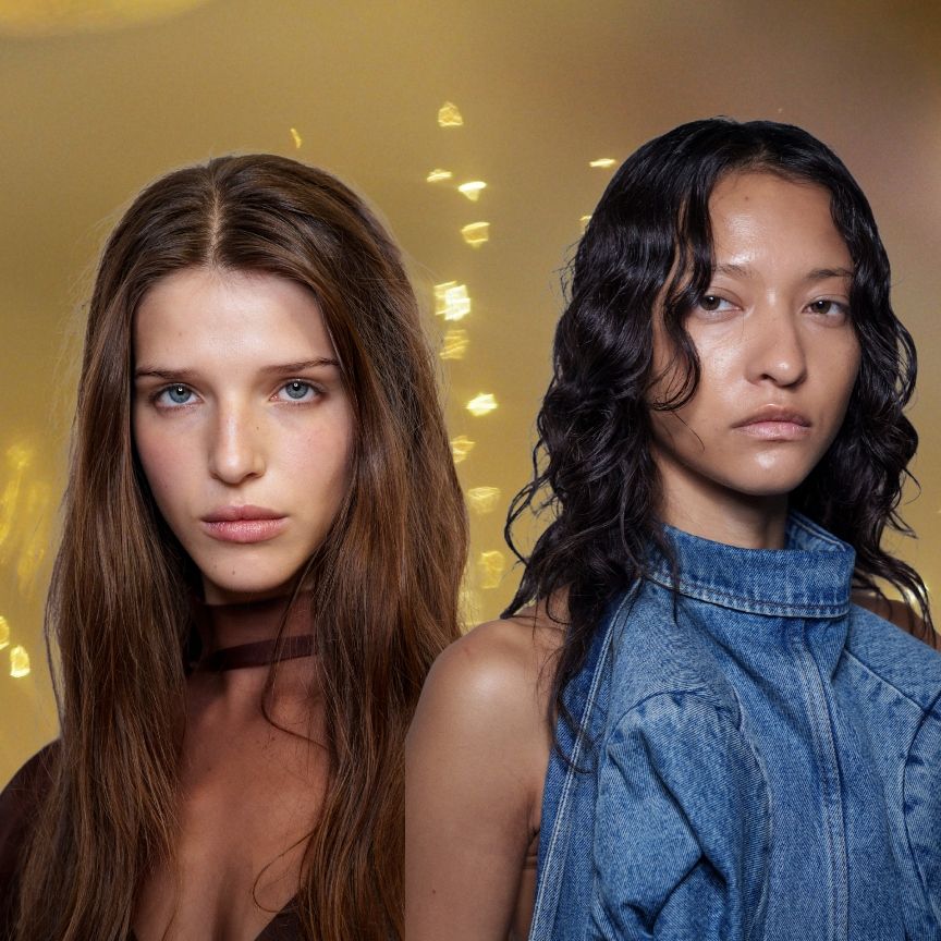two women with glowing skin on a gold background