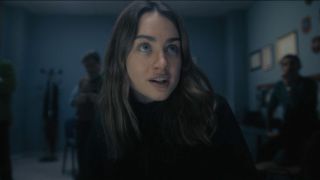 Grace Van Patten as Amanda Knox looking up.