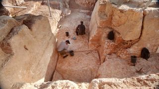 Two people at the quarry excavation site.