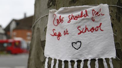 A sign reads 'Girls Should Feel Safe at School' outside a school in Hampstead