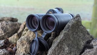 The binoculars on a stone wall in the countryside