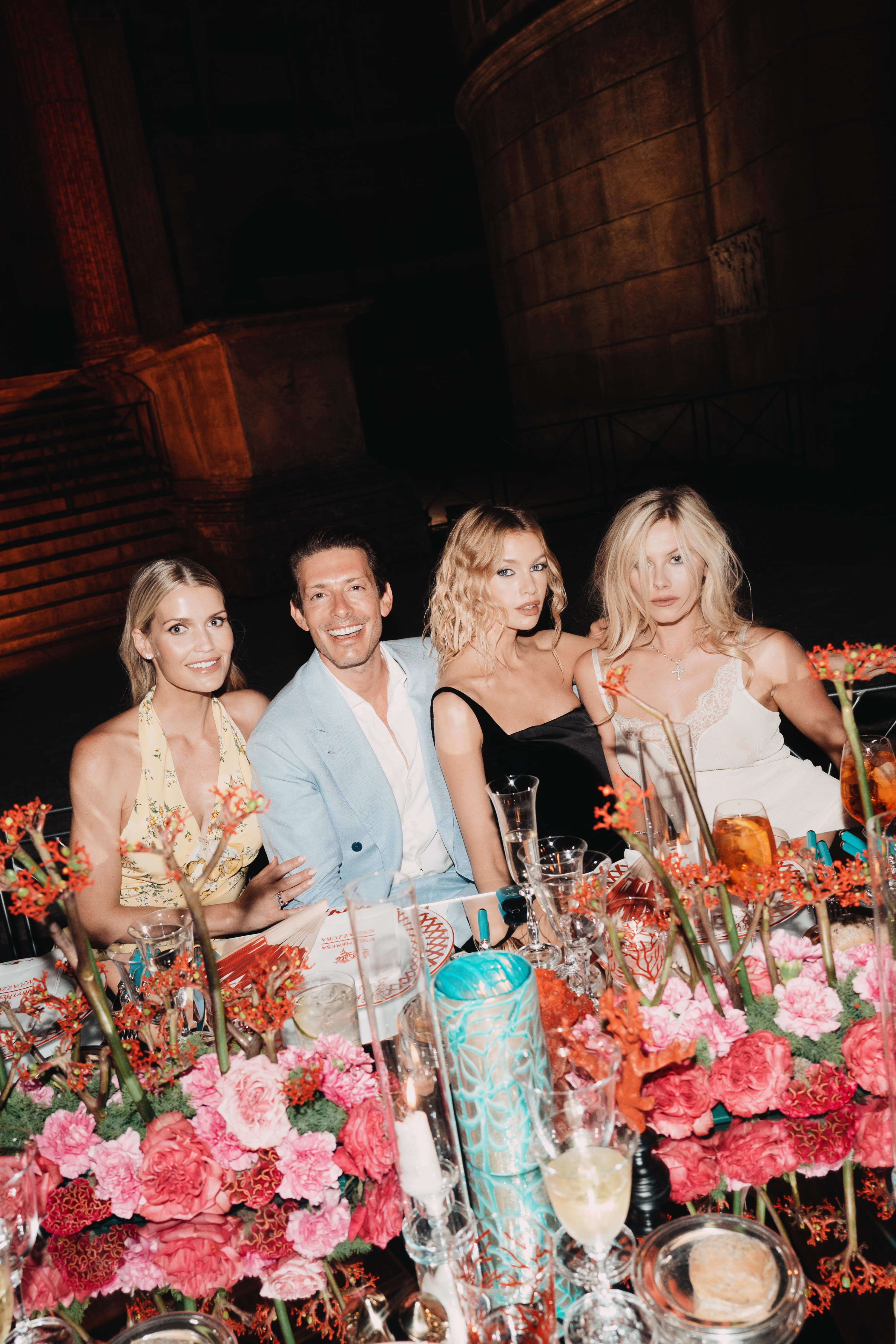 Lady Kitty Spencer, Edgardo Osorio, Stella Maxwell and Lady Lola Bute posing at a floral-covered table