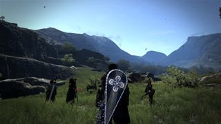 Heroes from Dragon's Dogma gaze across fields and hills.