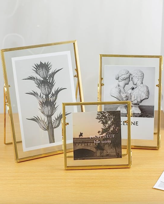 three gold photo frames with pictures