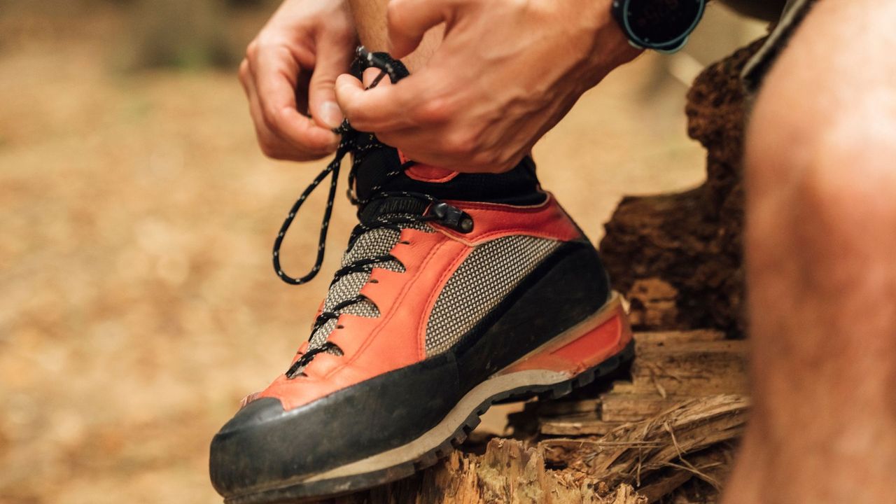 Person lacing up their hiking boots