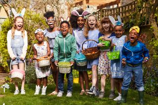 A group of kids dressed and ready to play Easter games in the garden.