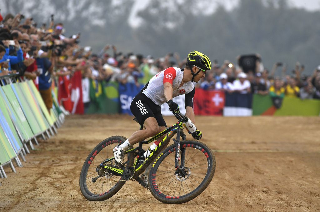 Having crossed the line, Nino Schurter (Switzerland) circles around to celebrate his gold medal