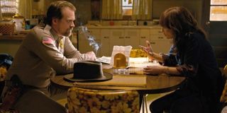 Stranger Things 3 Hopper smokes as Joyce tells him a story at the kitchen table