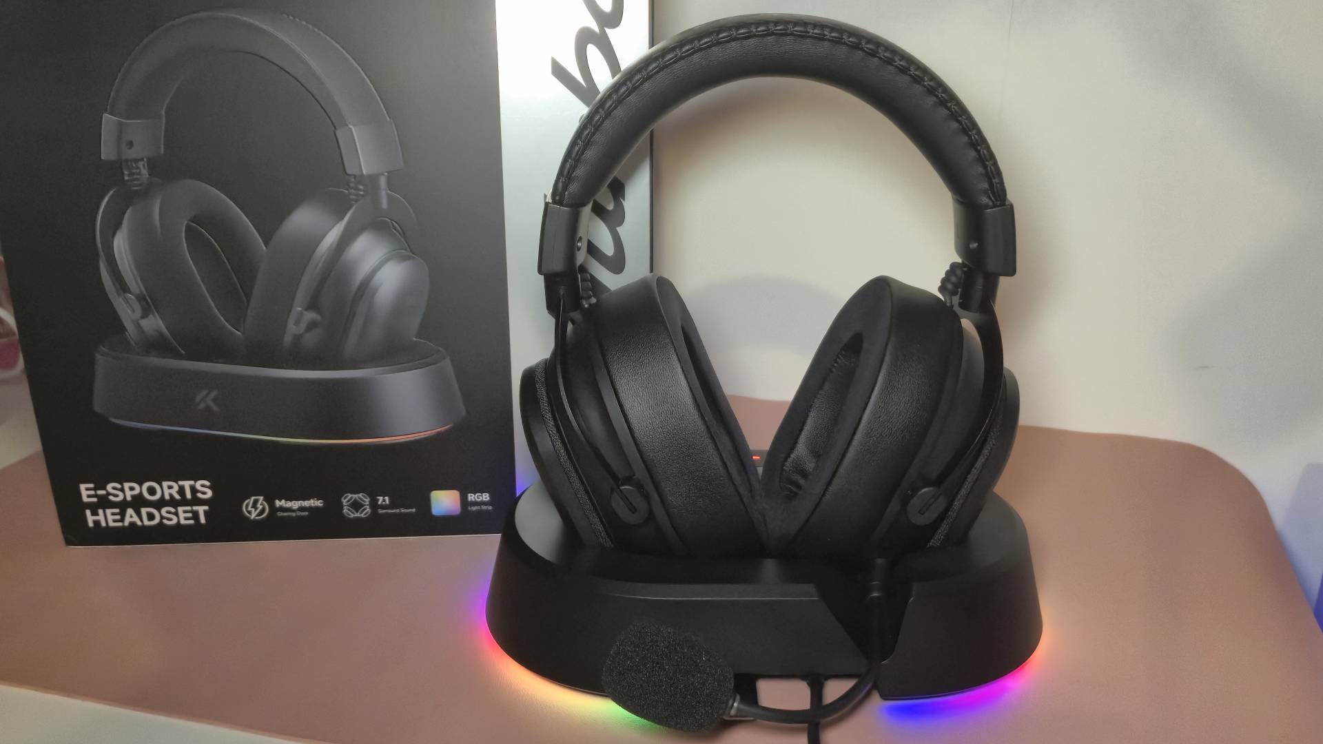 Photo of the Mchose V9 Turbo in its stand sitting in front of its box packaging.