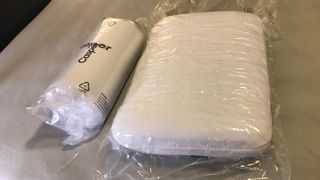 Two Casper Foam Pillowd with Snow Technology, one unwrapped and one still rolled up