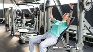 Woman uses Smith machine