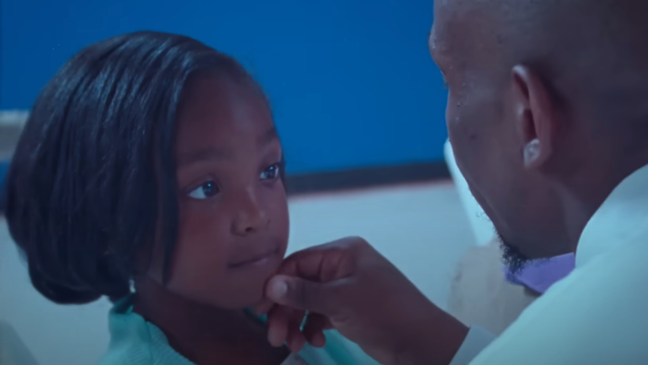 A young girl looks at her dad in Daughters