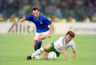 Republic of Ireland player Ray Houghton is challenged by Salvatore Schillaci during the 1990 FIFA World Cup quarter Final defeat against Italy at the Olympic Stadium on June 30, 1990 in Rome, Italy.