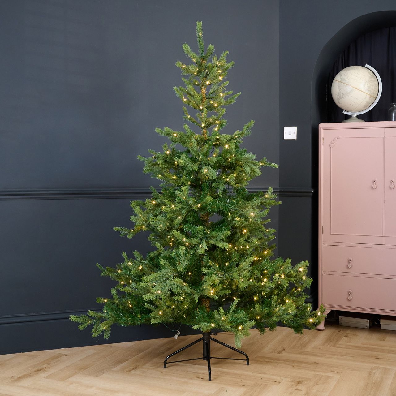 Cox &amp; Cox's 6ft Bergen Spruce Pre-Lit Christmas Tree in a black-painted living room
