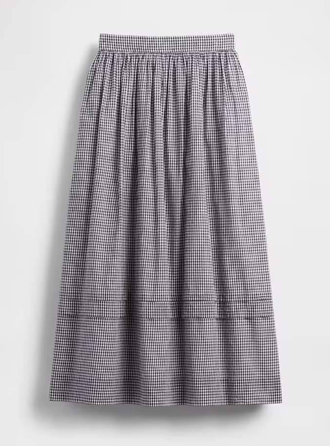 a gingham maxi skirt in front of a plain backdrop