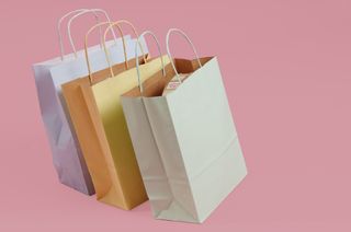 colorful shopping backs on a pink background