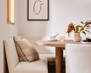 Breakfast nook with neutral bench and throw pillow